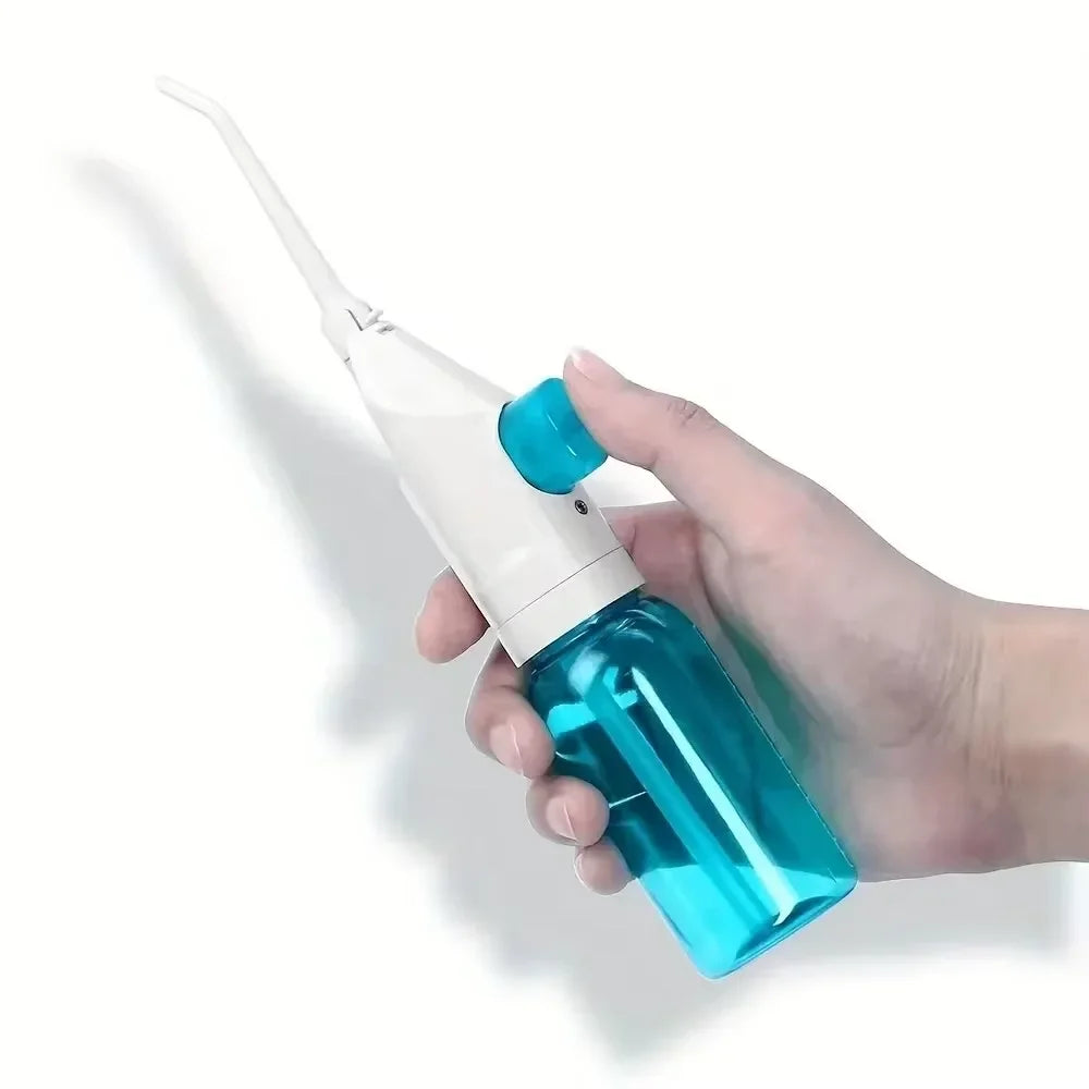183---Portable high-pressure oral irrigator - manual tooth cleaner with grip, nozzle attachment for gum health